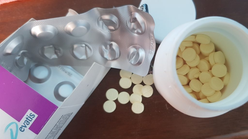 image of tablets in a bottle and a blister pack