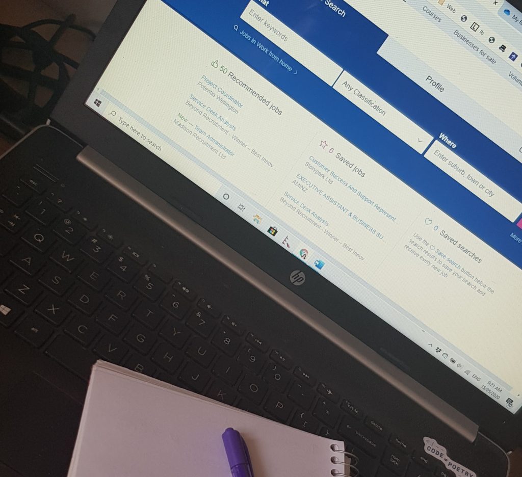 image of open laptop and notebook.